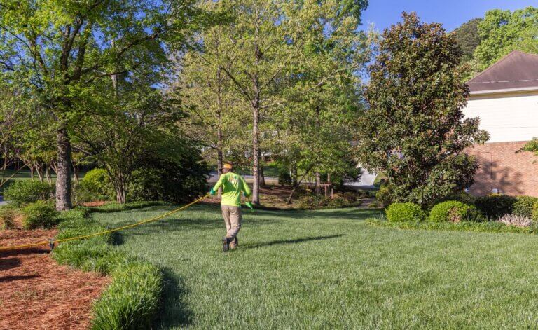 Photo of a Simply Green service manager applying liquid aeration solution