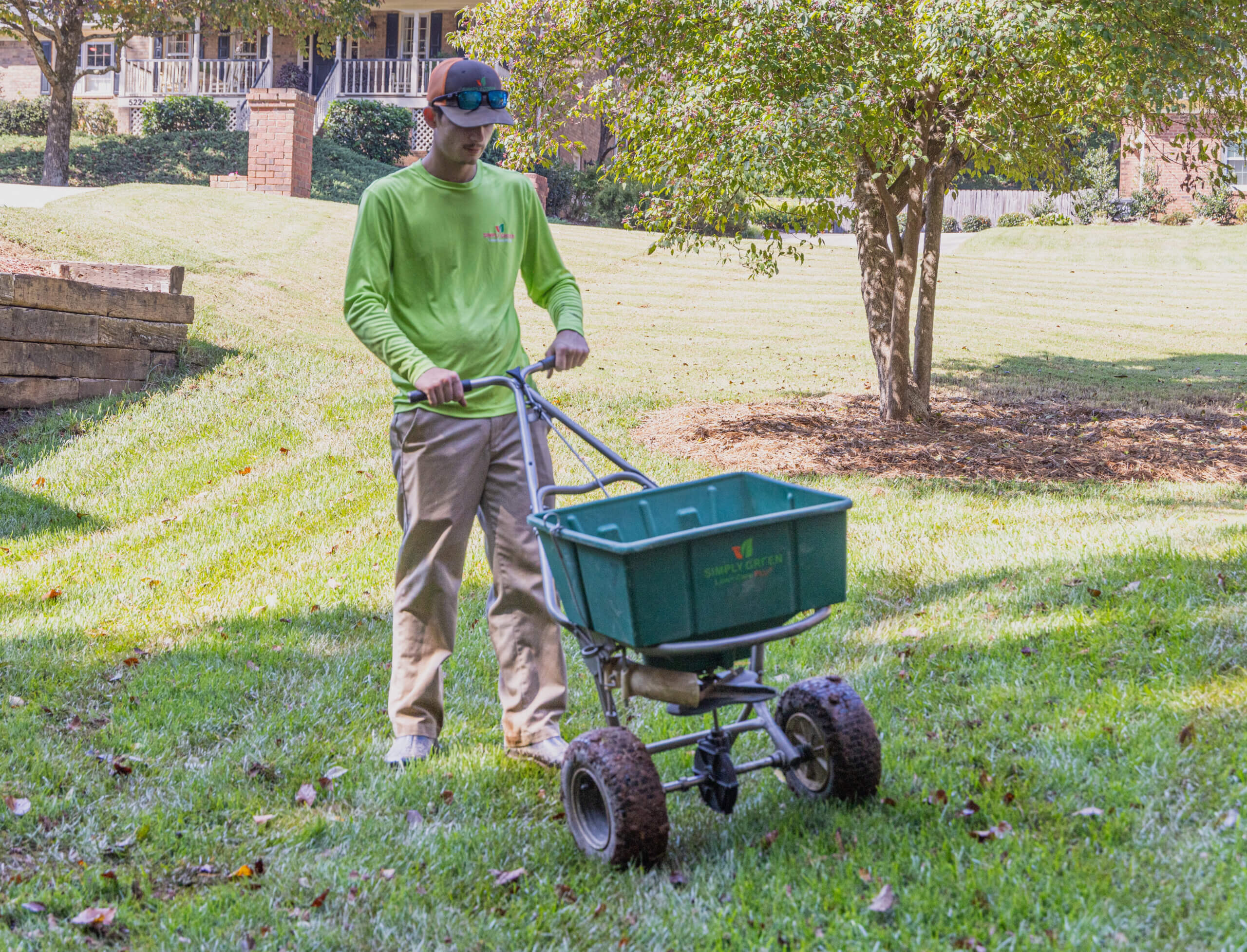 Simply Green Lawn Care Technician spreading fescue seeds